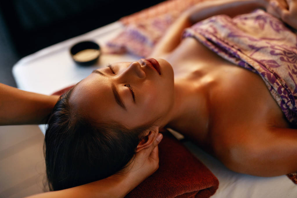 Spa Massage. Hands Massaging Woman Head At Thai Beauty Salon. Asian Girl Enjoying Massage Therapy. High Resolution